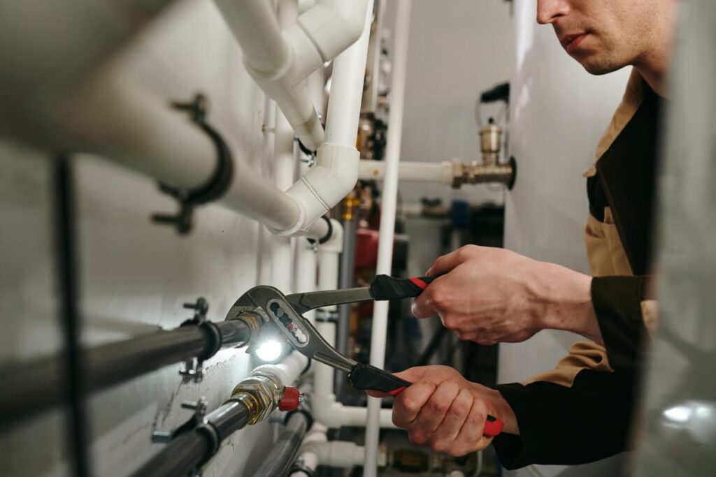 Plumbers maintaining commercial plumbing pipes in Clermont
