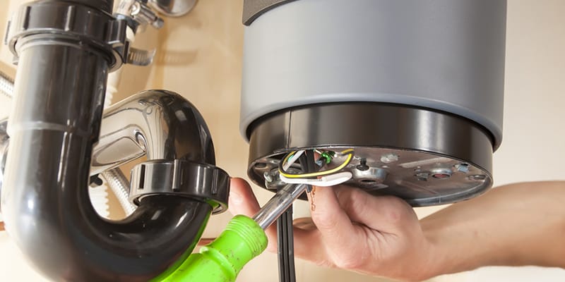 Technician repairing the heating element of a water heater in Clermont