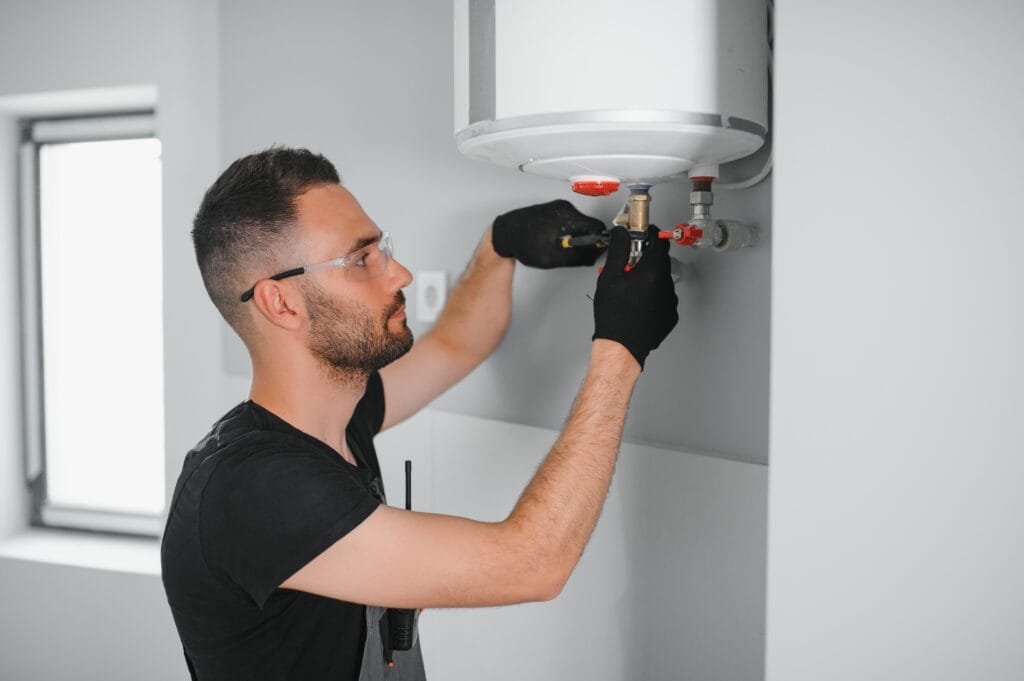 Technician performing water heater maintenance in Clermont