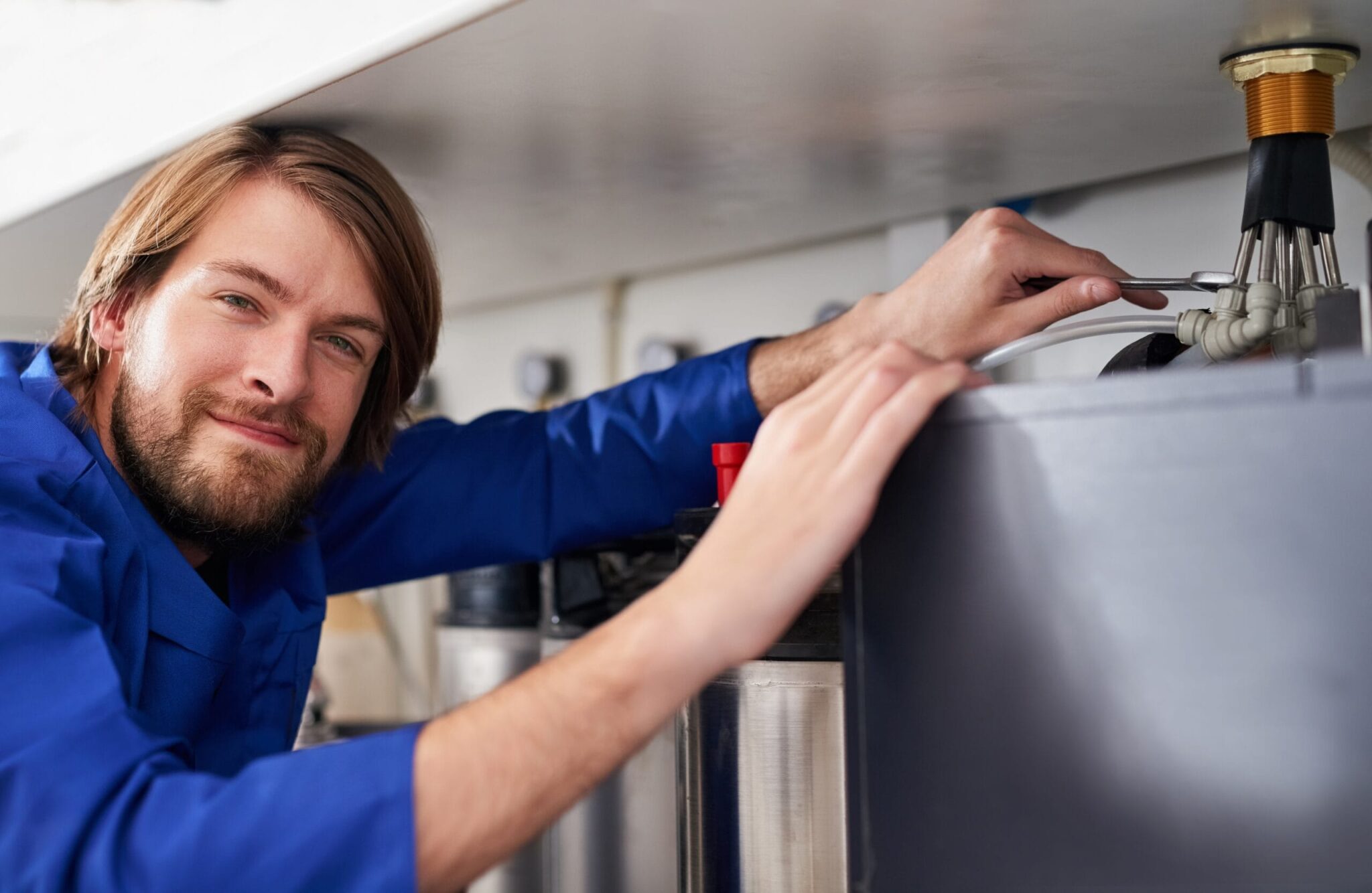 Technician servicing a residential water heater tank in Clermont
