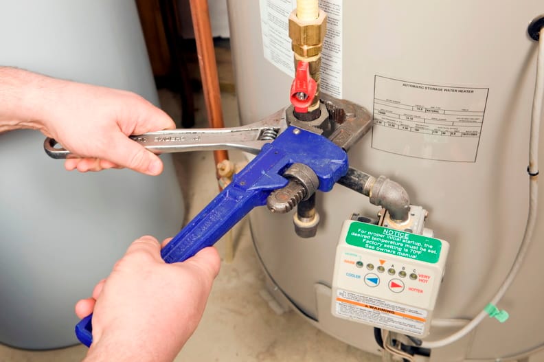 Plumber repairing a water heater valve in Clermont